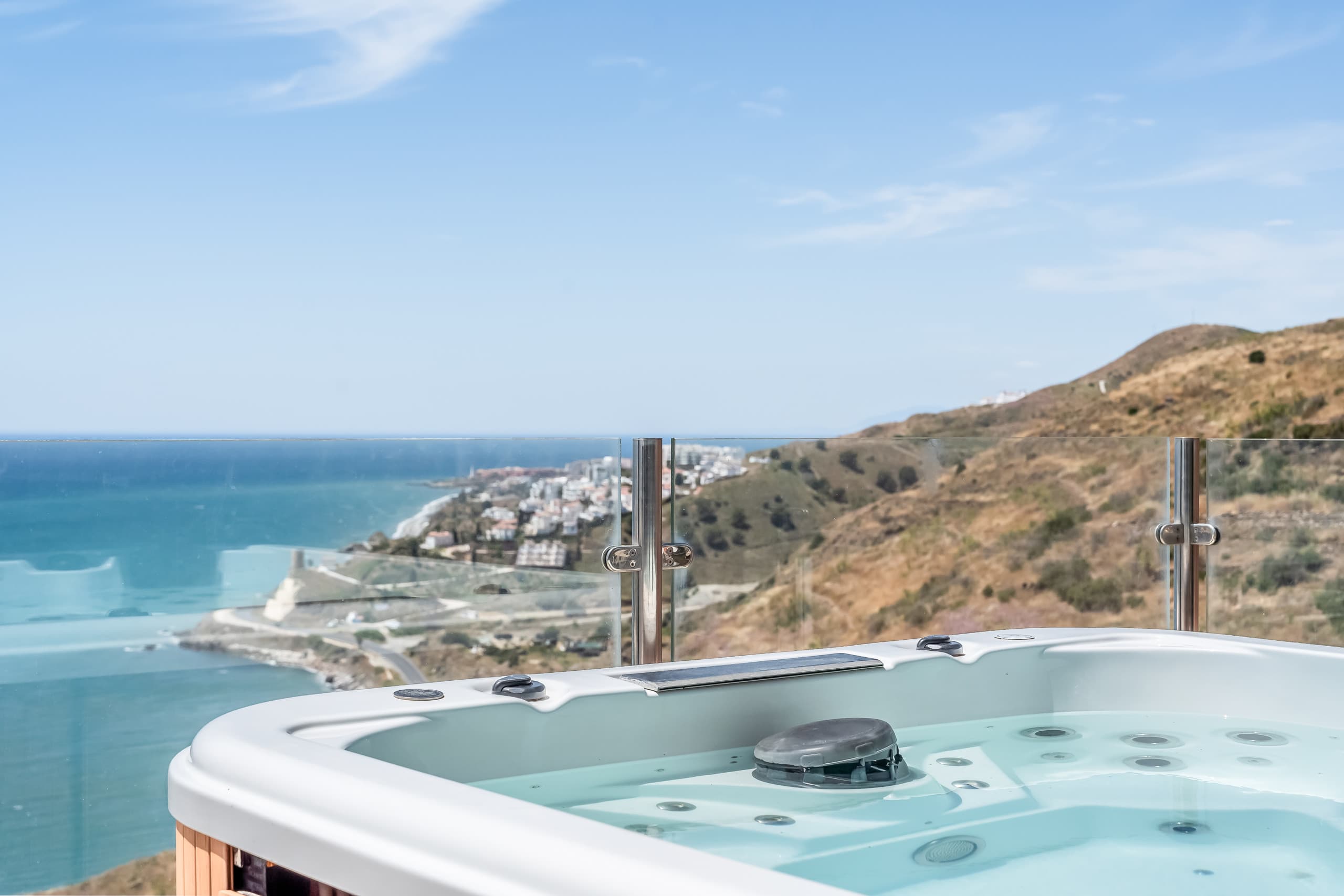 Rooftop infinity pool with jacuzzi at golden hour, overlooking the Mediterranean
